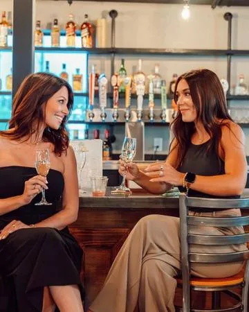 Keirsten Hopke and Carissa Vale, GrowthHouse Digital co-founders, sharing a drink at a bar