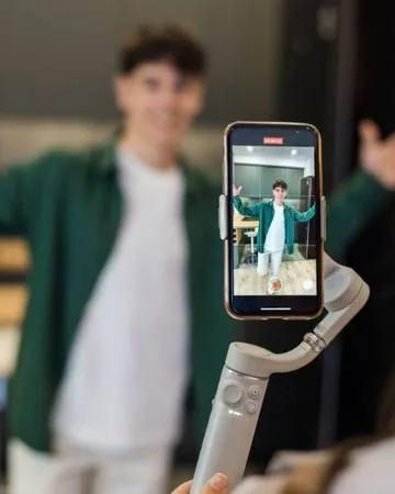 Creator filming a social media video on a smartphone gimbal